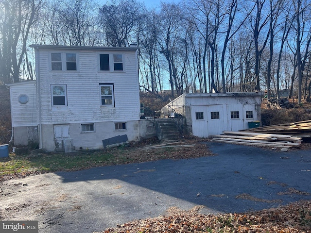 view of side of home with a storage shed