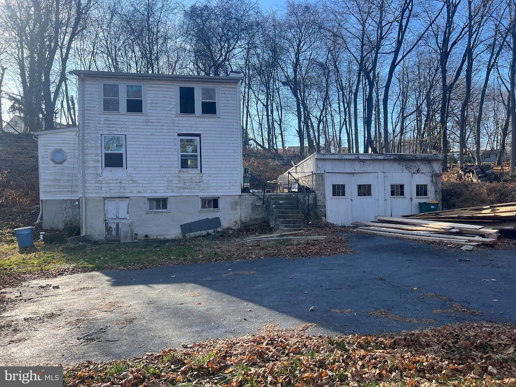 view of side of home with a shed