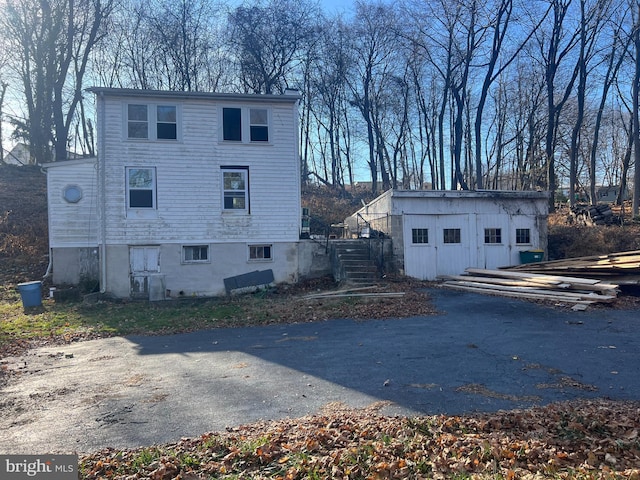 view of side of home with a shed