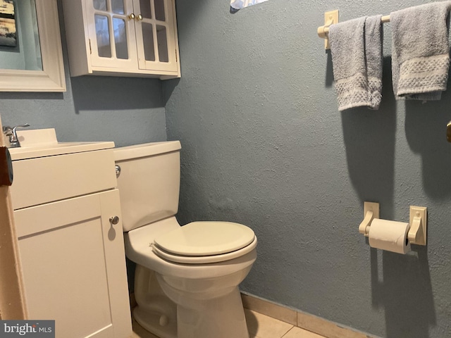 bathroom featuring tile patterned floors, toilet, and vanity