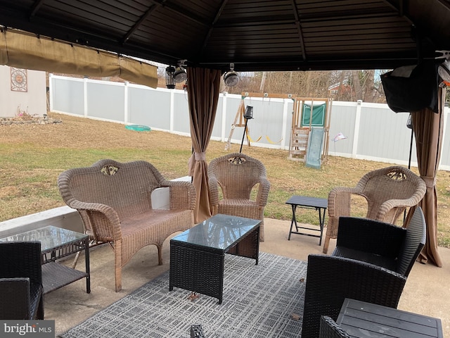 view of patio / terrace featuring a gazebo, an outdoor living space, and a playground