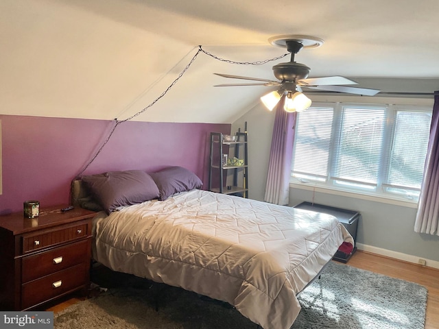 bedroom featuring lofted ceiling, light hardwood / wood-style floors, and ceiling fan