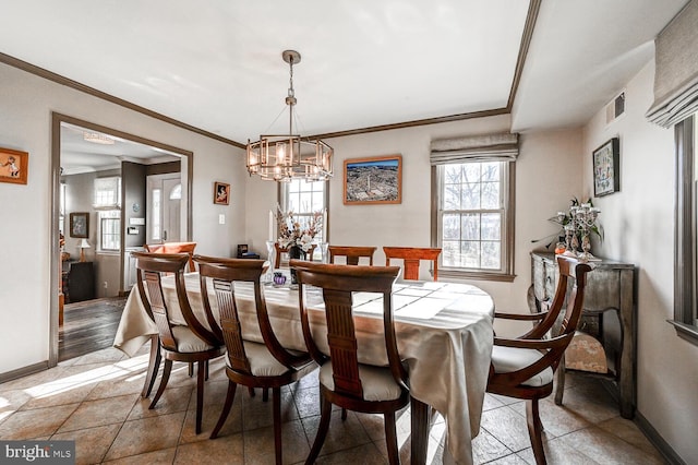 dining area featuring ornamental molding and a notable chandelier