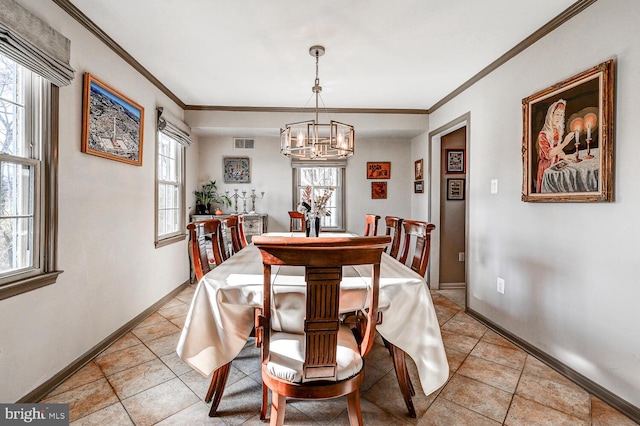 tiled dining area featuring ornamental molding and an inviting chandelier