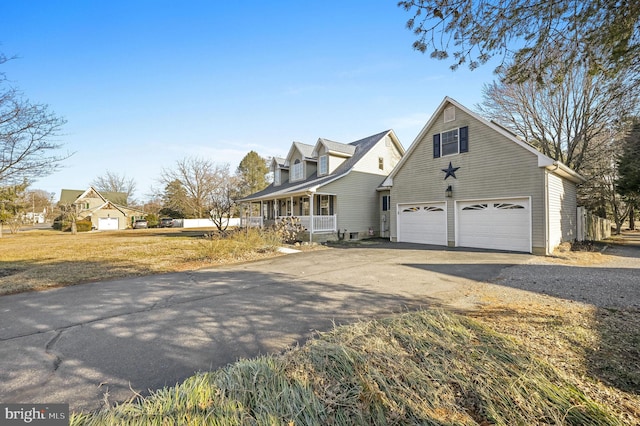 view of front facade with a porch, a garage, and a front yard