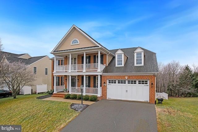 neoclassical / greek revival house featuring a garage, a front yard, and covered porch