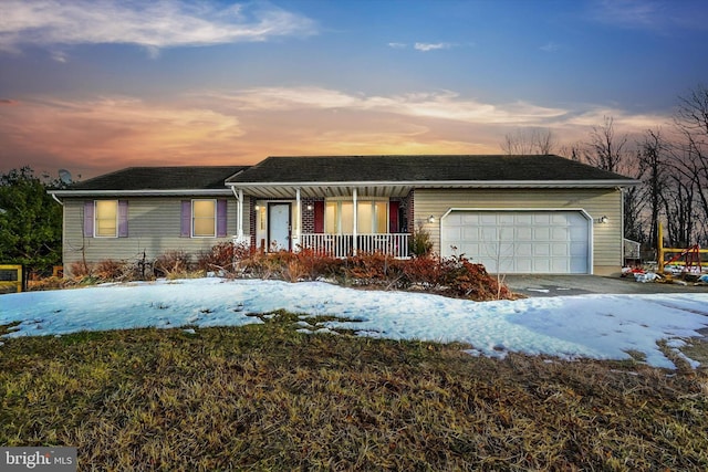 ranch-style house with a garage and covered porch