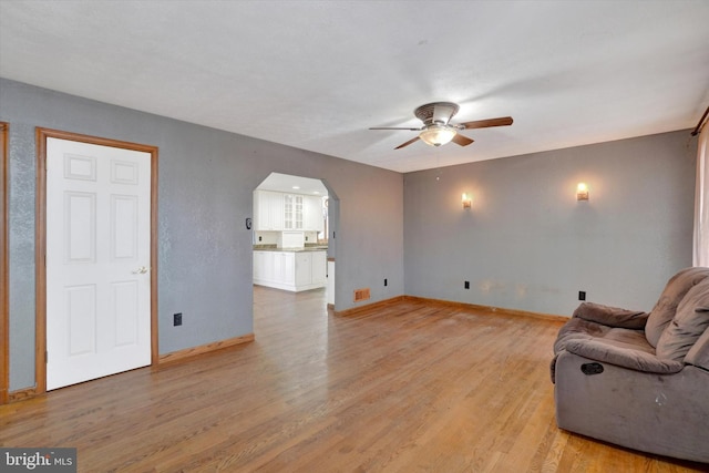 unfurnished living room with light hardwood / wood-style floors and ceiling fan