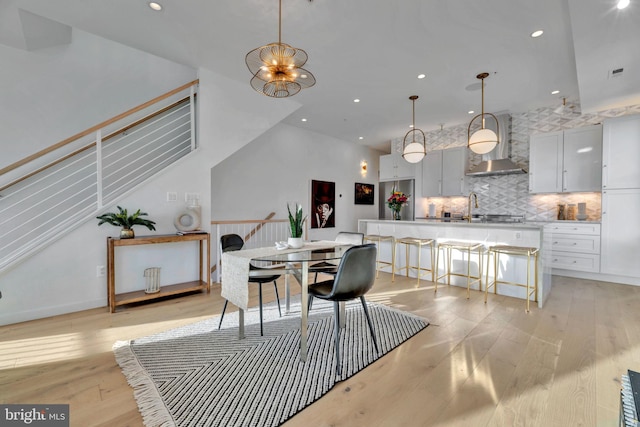 dining space featuring an inviting chandelier and light hardwood / wood-style flooring