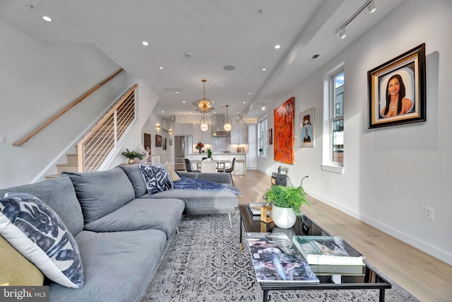 living room with track lighting and light wood-type flooring