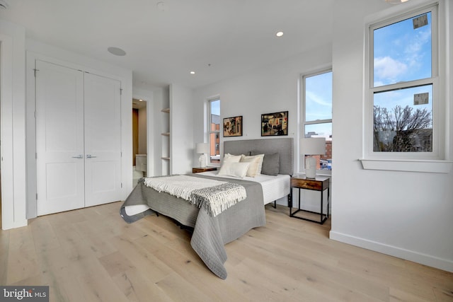 bedroom featuring light wood-type flooring and a closet