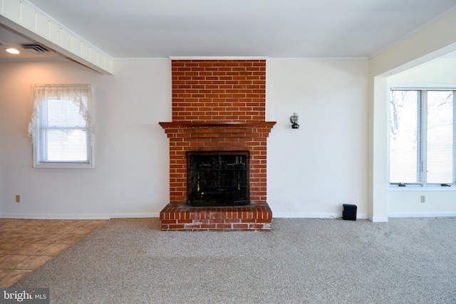 unfurnished living room featuring ornamental molding, carpet flooring, and a brick fireplace