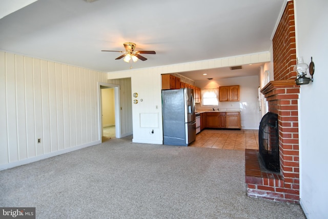 unfurnished living room with ceiling fan and light colored carpet