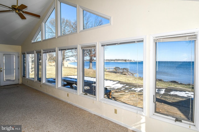 unfurnished sunroom with a water view, ceiling fan, and vaulted ceiling