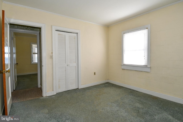 unfurnished bedroom featuring multiple windows, ornamental molding, a closet, and dark colored carpet