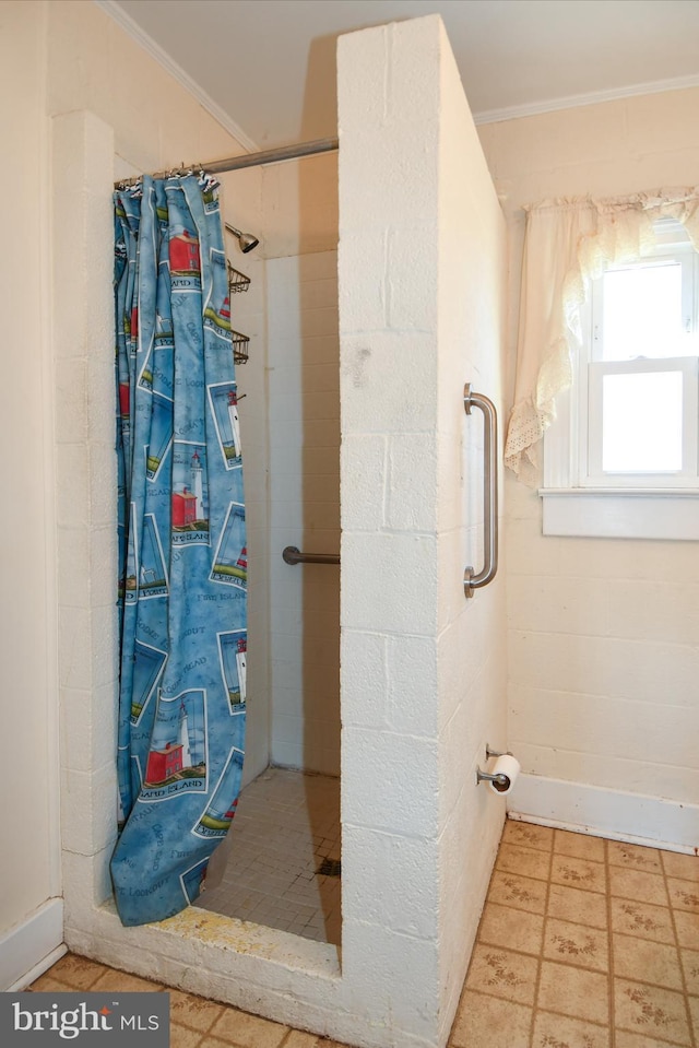 bathroom featuring ornamental molding and a shower with curtain