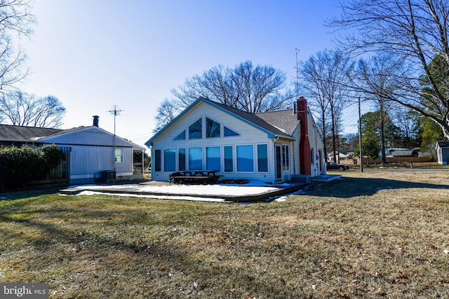 rear view of property with a lawn