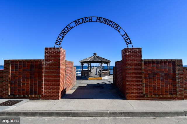 surrounding community with a gazebo and a water view