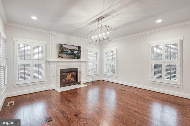 unfurnished living room featuring crown molding, hardwood / wood-style floors, and a wealth of natural light