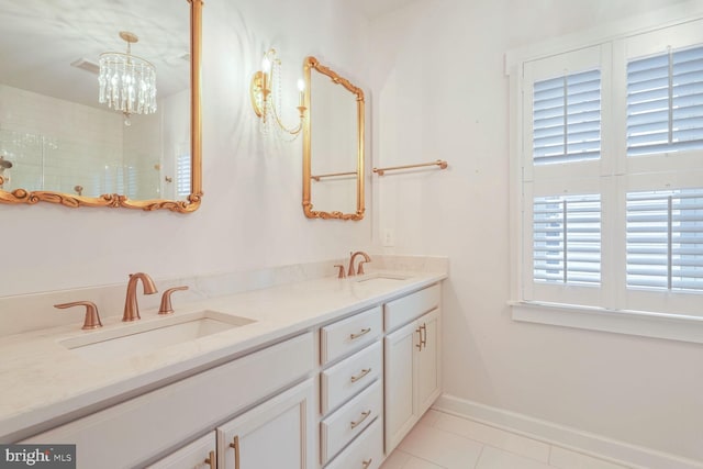 bathroom featuring an inviting chandelier, vanity, and tile patterned flooring