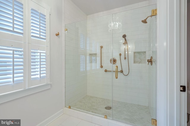 bathroom featuring tile patterned floors and a shower with door