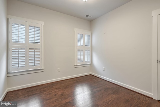 unfurnished room featuring dark wood-type flooring