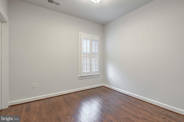 unfurnished room featuring dark hardwood / wood-style floors