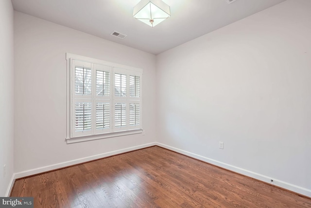 unfurnished room with wood-type flooring