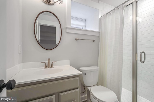 bathroom featuring vanity, toilet, and a shower with shower curtain