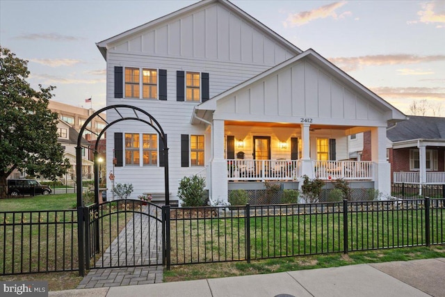 view of front of property with a yard and covered porch