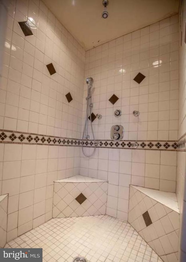 bathroom with tiled shower