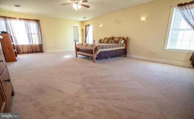 bedroom featuring ceiling fan and light carpet