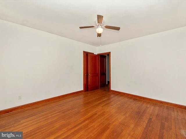 empty room with hardwood / wood-style flooring and ceiling fan