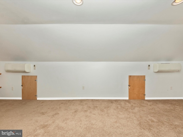 additional living space with vaulted ceiling, carpet, and an AC wall unit