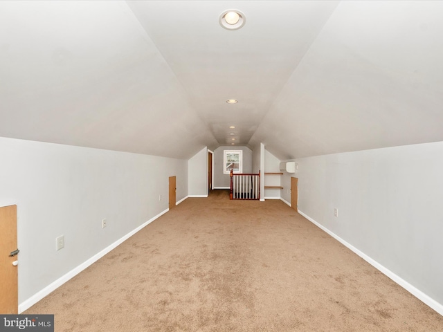 additional living space featuring lofted ceiling and carpet