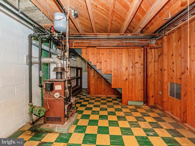 basement featuring wood walls