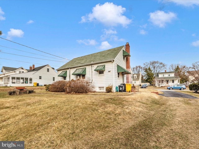 view of side of property featuring a yard