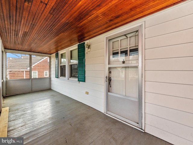 unfurnished sunroom with wood ceiling