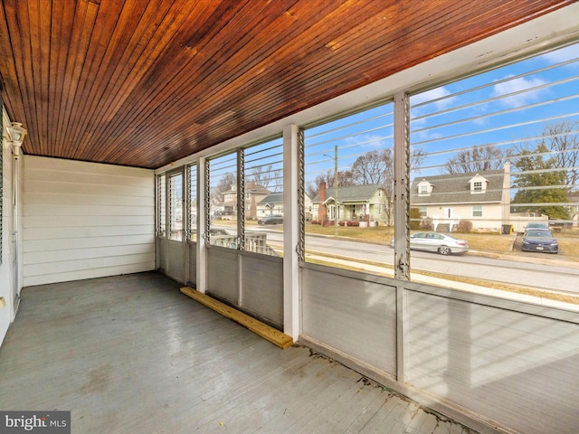 unfurnished sunroom featuring a healthy amount of sunlight and wooden ceiling