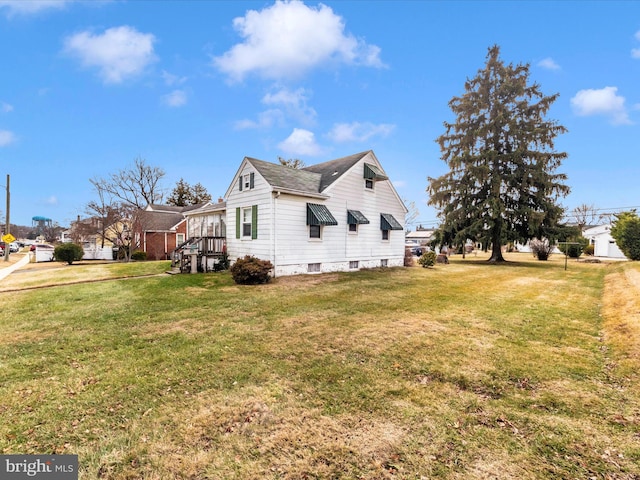 view of side of home featuring a yard