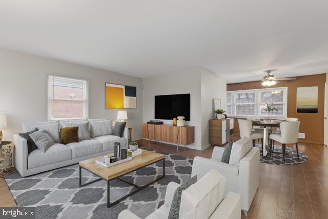 living room featuring hardwood / wood-style floors, a healthy amount of sunlight, and ceiling fan