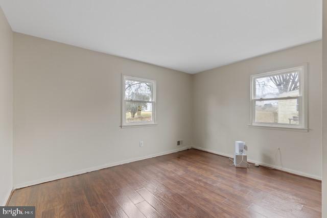 spare room featuring hardwood / wood-style flooring