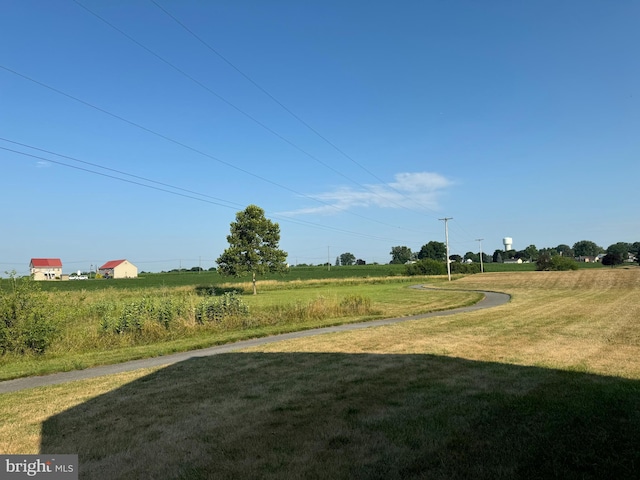 view of yard with a rural view