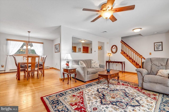 living room featuring hardwood / wood-style flooring and ceiling fan