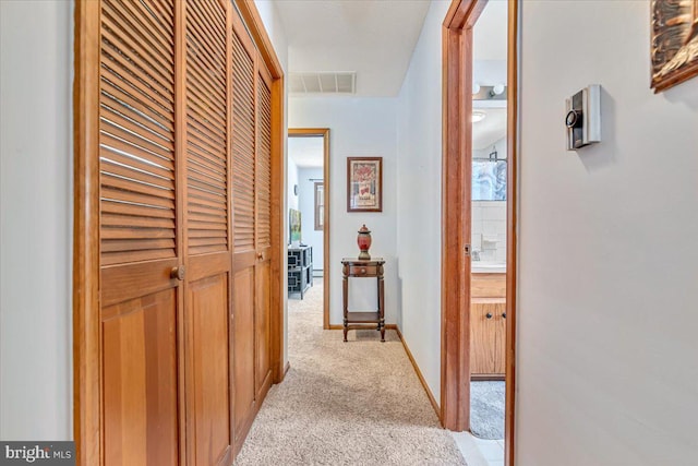 hallway featuring light carpet