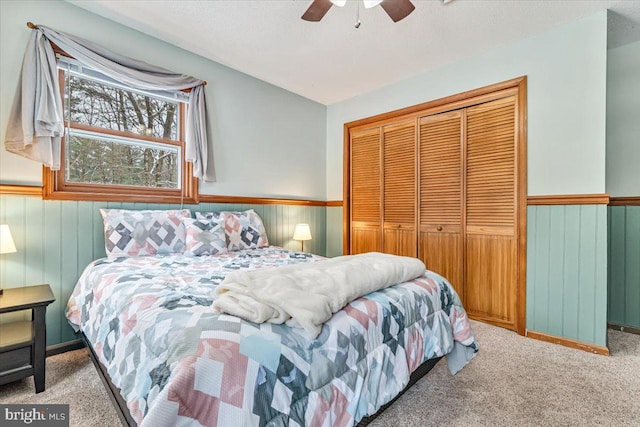 carpeted bedroom featuring a textured ceiling, a closet, and ceiling fan