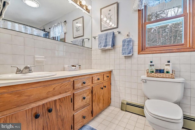 bathroom featuring a baseboard radiator, vanity, toilet, and tile patterned flooring