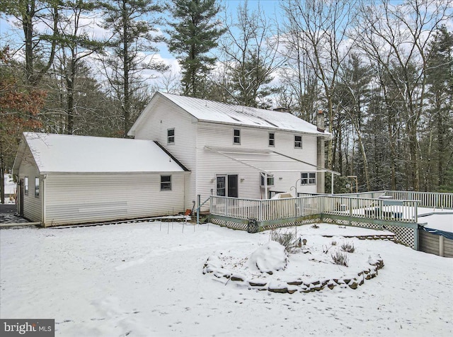 snow covered house with a deck