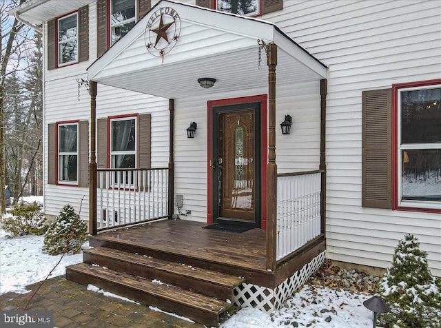 view of snow covered property entrance