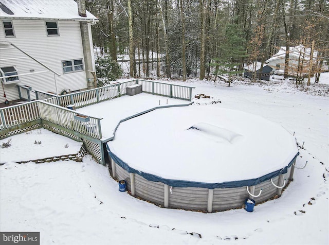 yard layered in snow with a wooden deck